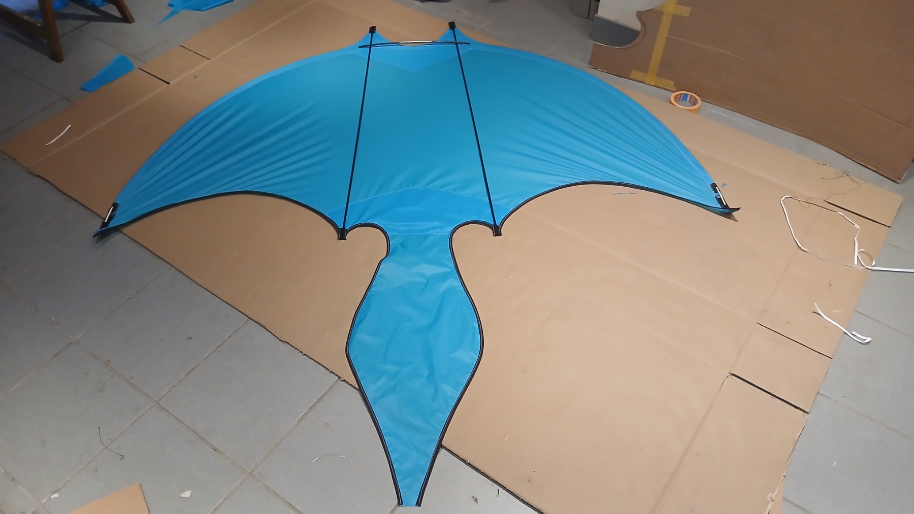 Kite canopy laid out on the workshop floor